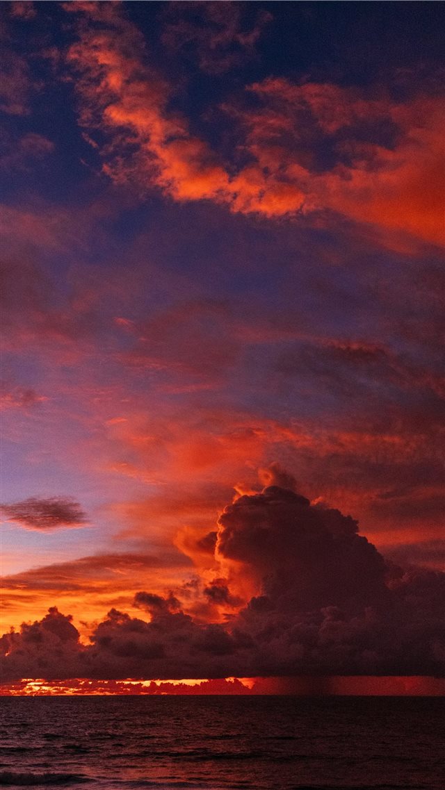 ocean under orange colored clouds iPhone 8 wallpaper 