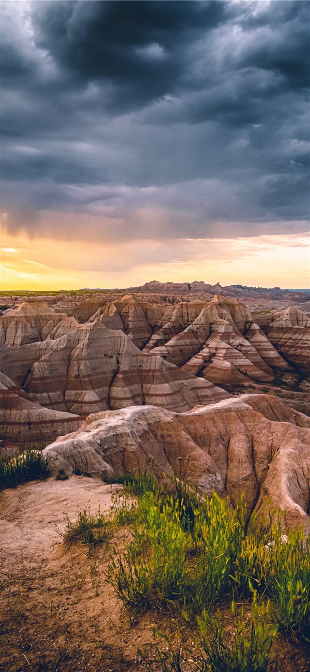 A morning storm in the Badlands being chased away ... iPhone X wallpaper 