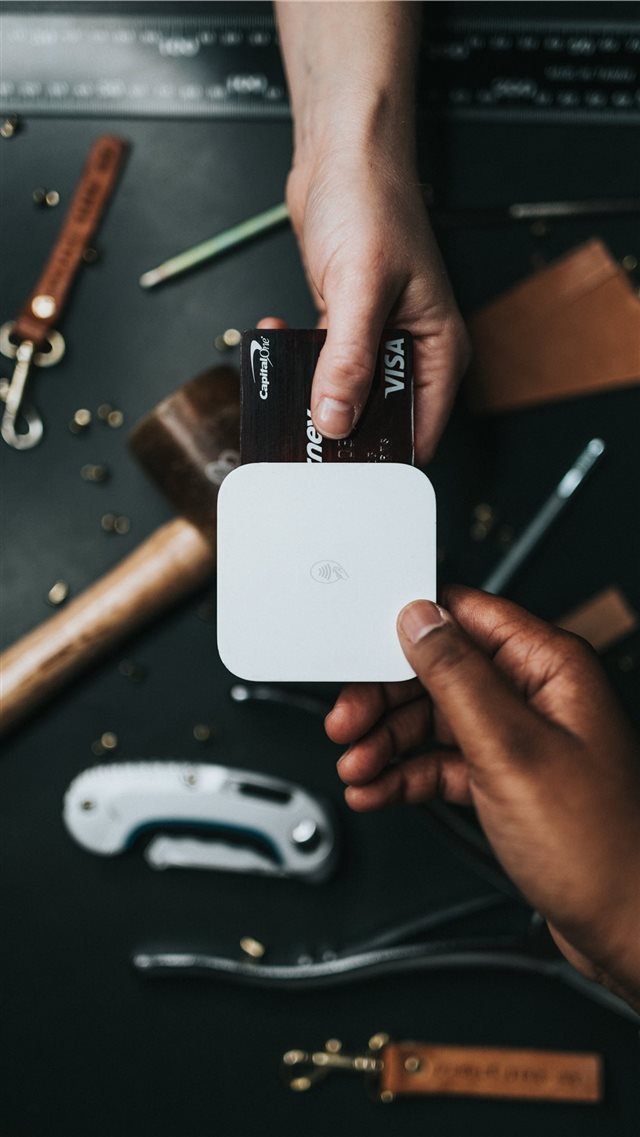 person holding Visa card and white device iPhone 8 wallpaper 