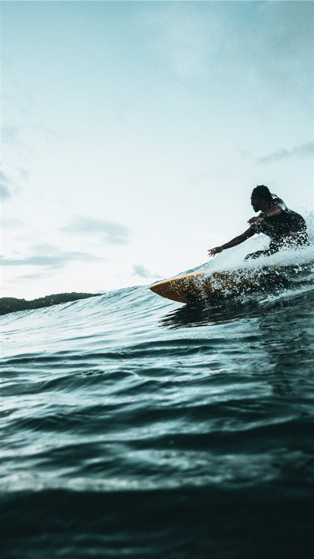man surfboarding during daytime iPhone 8 wallpaper 
