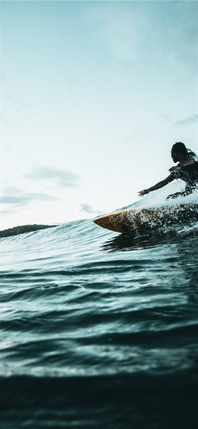 man surfboarding during daytime iPhone X wallpaper 