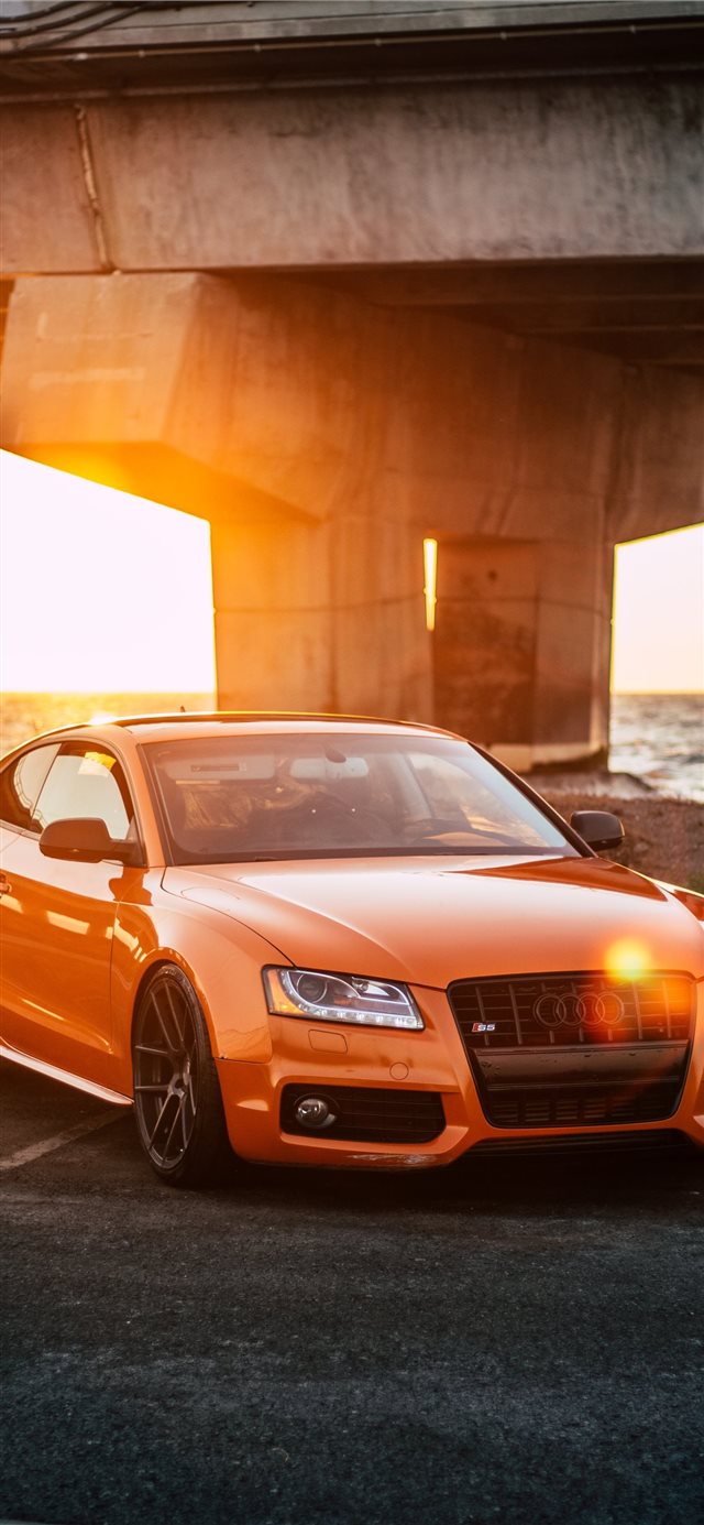 orange Audi coupe parked on gray concrete road iPhone X wallpaper 