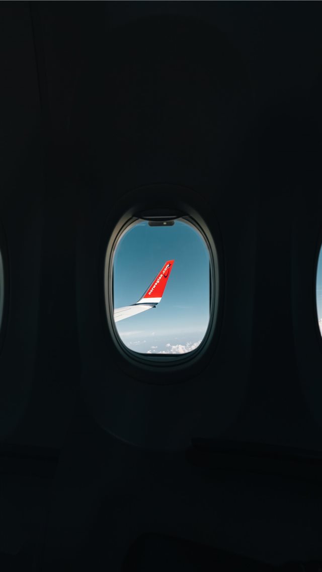 red airplane wing through window iPhone 8 wallpaper 
