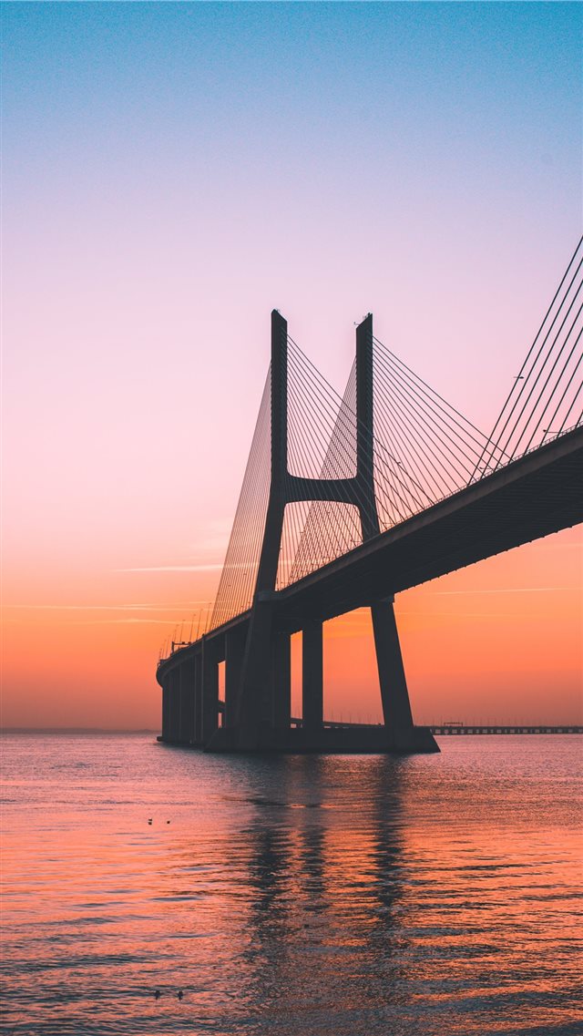silhouette of bridge under clear sky iPhone 8 wallpaper 