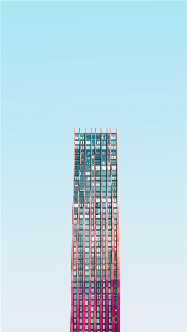 high rise building under blue skies daytime iPhone SE wallpaper 