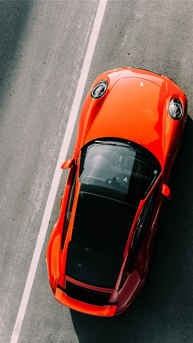 orange vehicle on road close up photography iPhone 8 wallpaper 