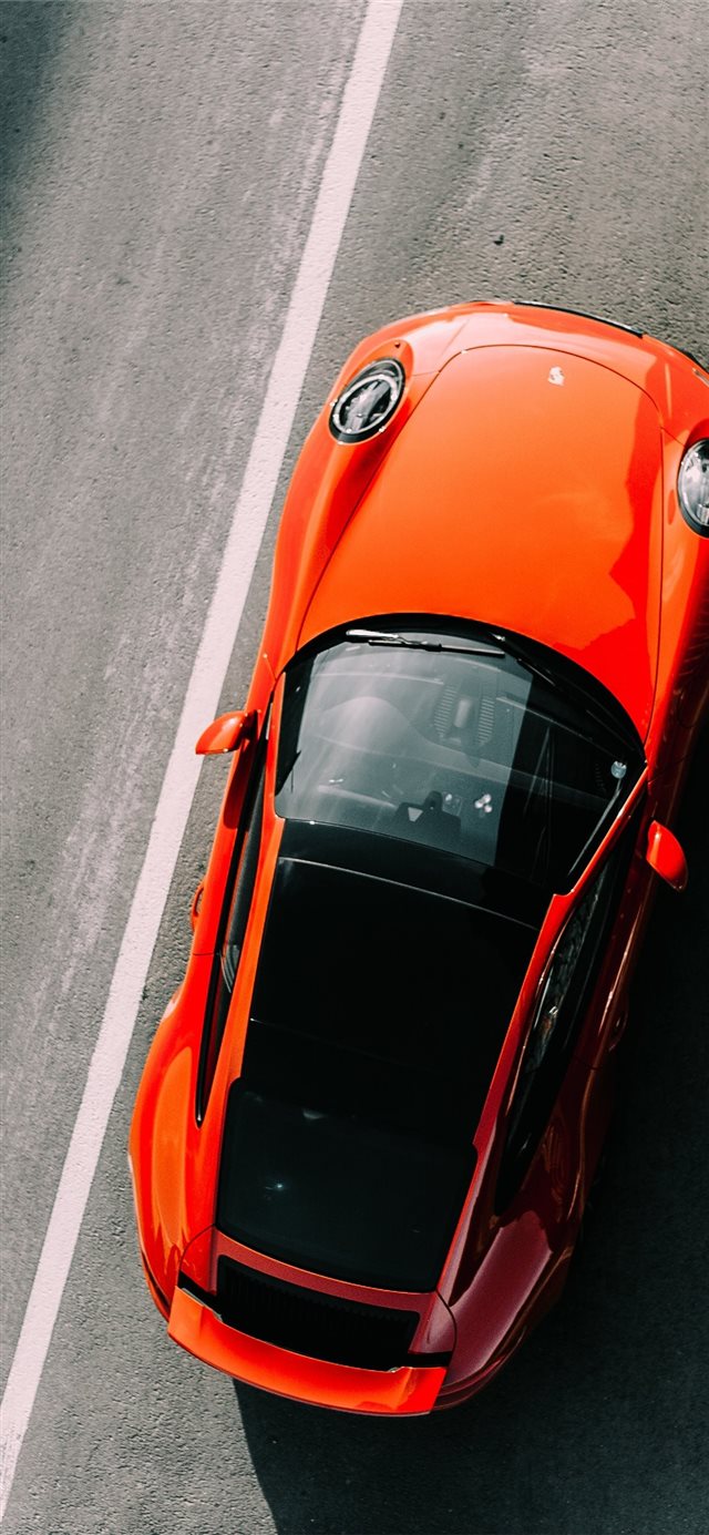 orange vehicle on road close up photography iPhone X wallpaper 