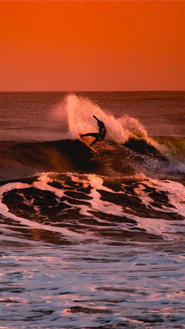 person surfing during sunset iPhone SE wallpaper 