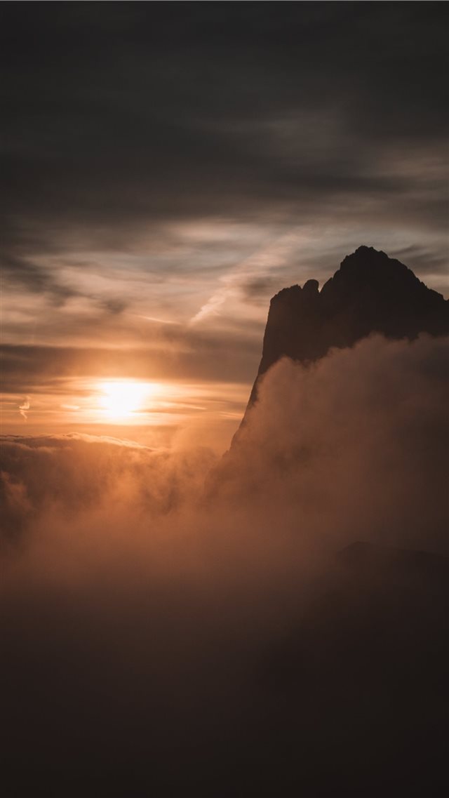 silhouette of mountain under cloudy sky iPhone SE wallpaper 