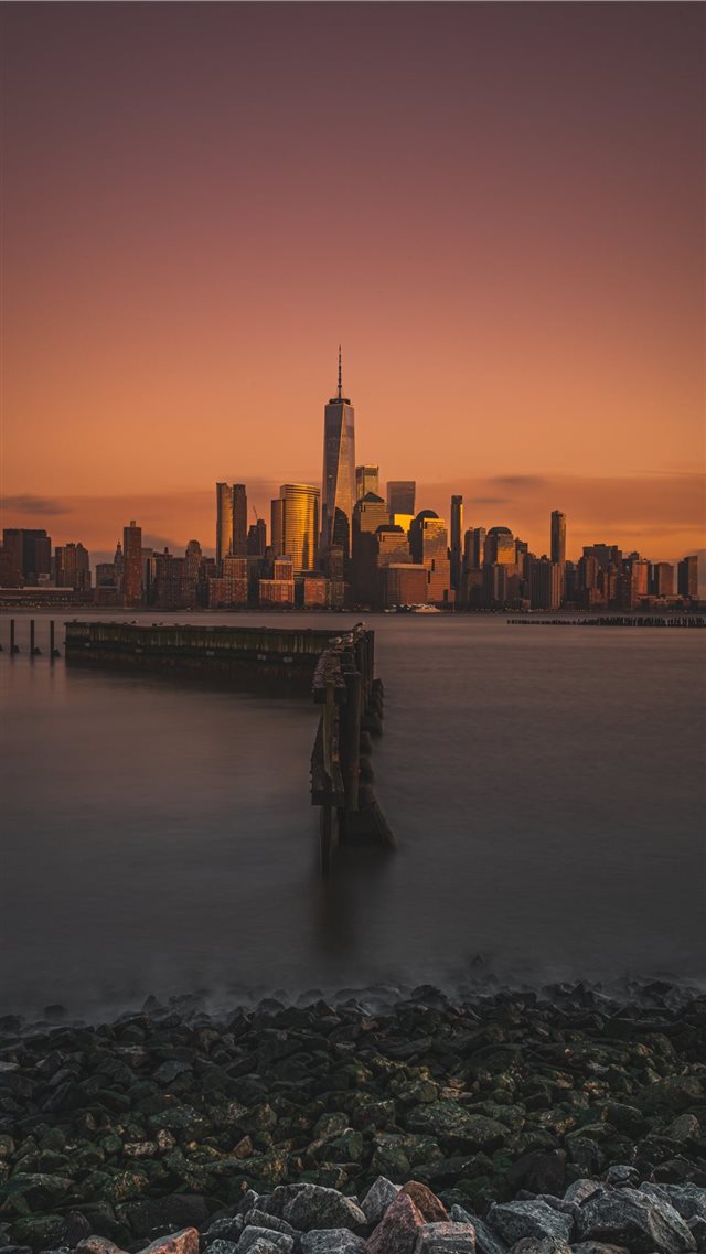 city and body of water during golden hour iPhone 8 wallpaper 