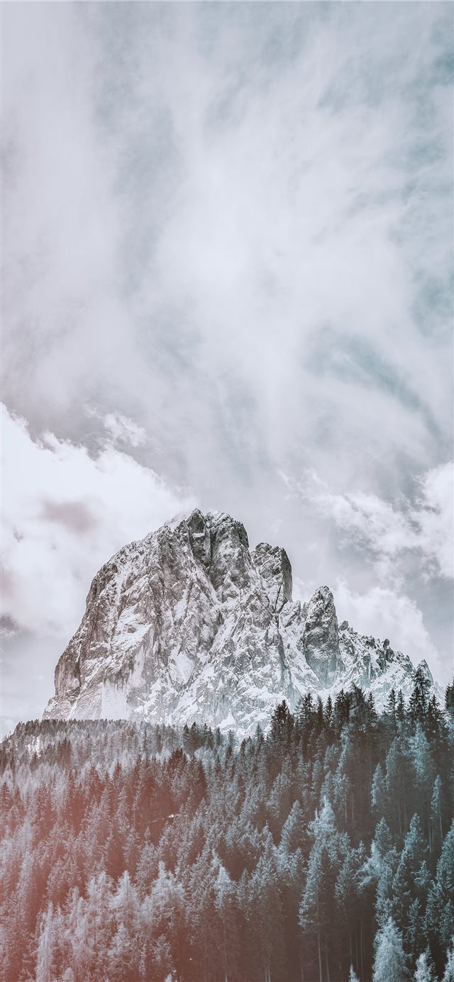mountain covered with snow under white cloud and b... iPhone X wallpaper 