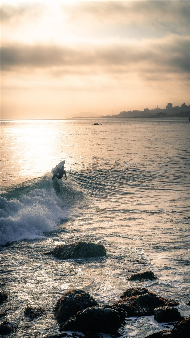 person surfing iPhone SE wallpaper 