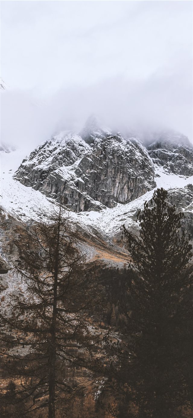 snow capped rocky mountain under cloudy sky iPhone X wallpaper 