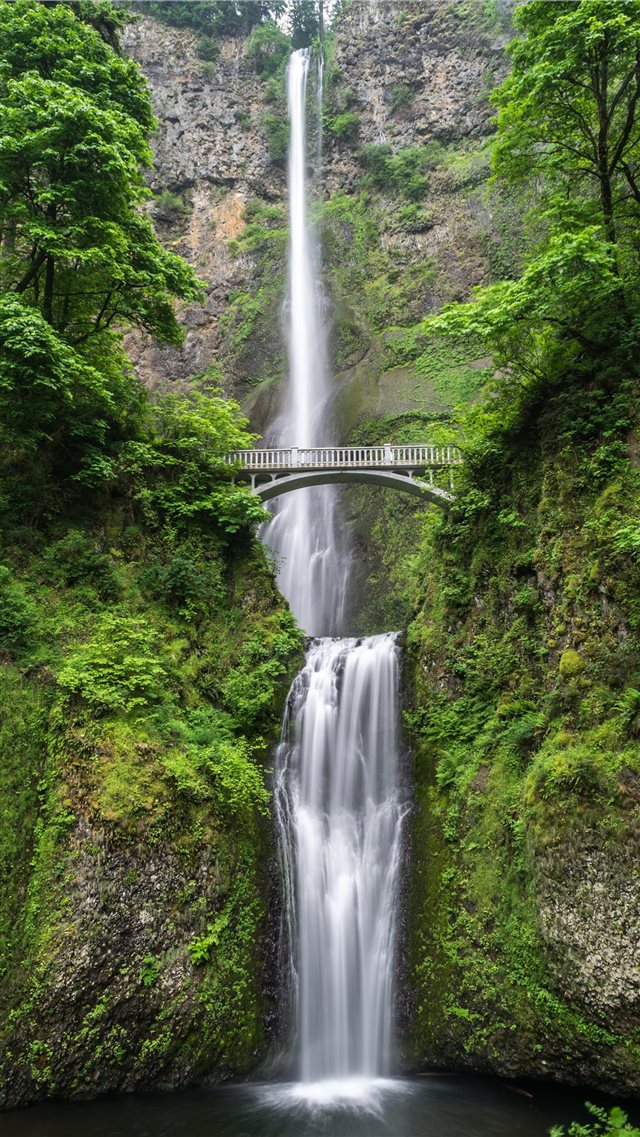gray concrete bridge and waterfalls during daytime iPhone 8 wallpaper 