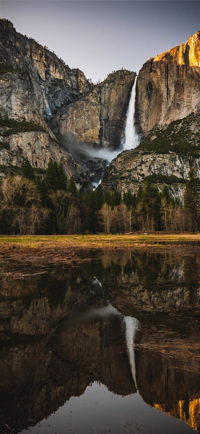 reflection of rock mountain and waterfalls on wate... iPhone X wallpaper 
