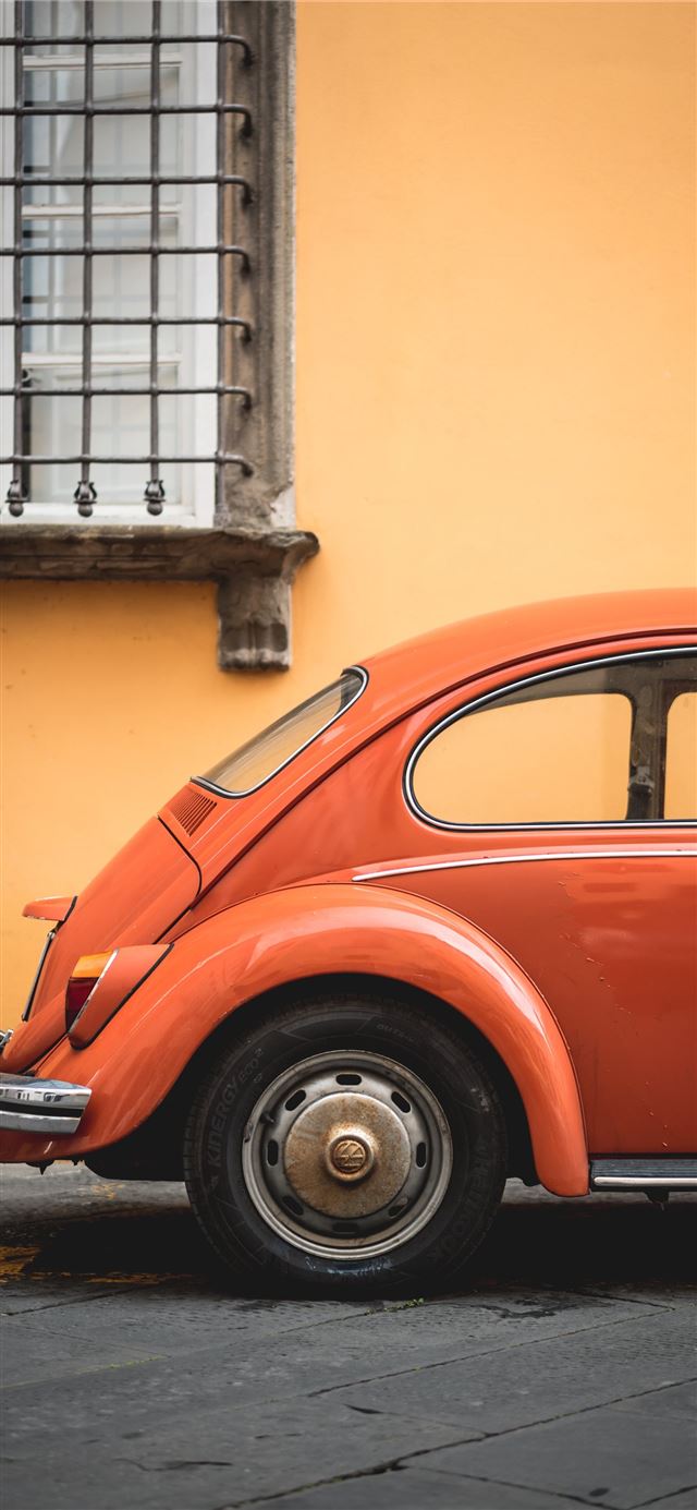shallow focus photo of orange Volkswagen Beetle iPhone X wallpaper 