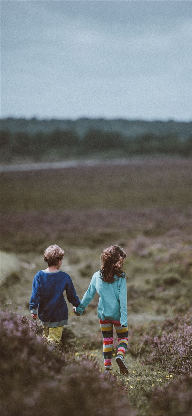 siblings walking holding hands and background iPhone X wallpaper 