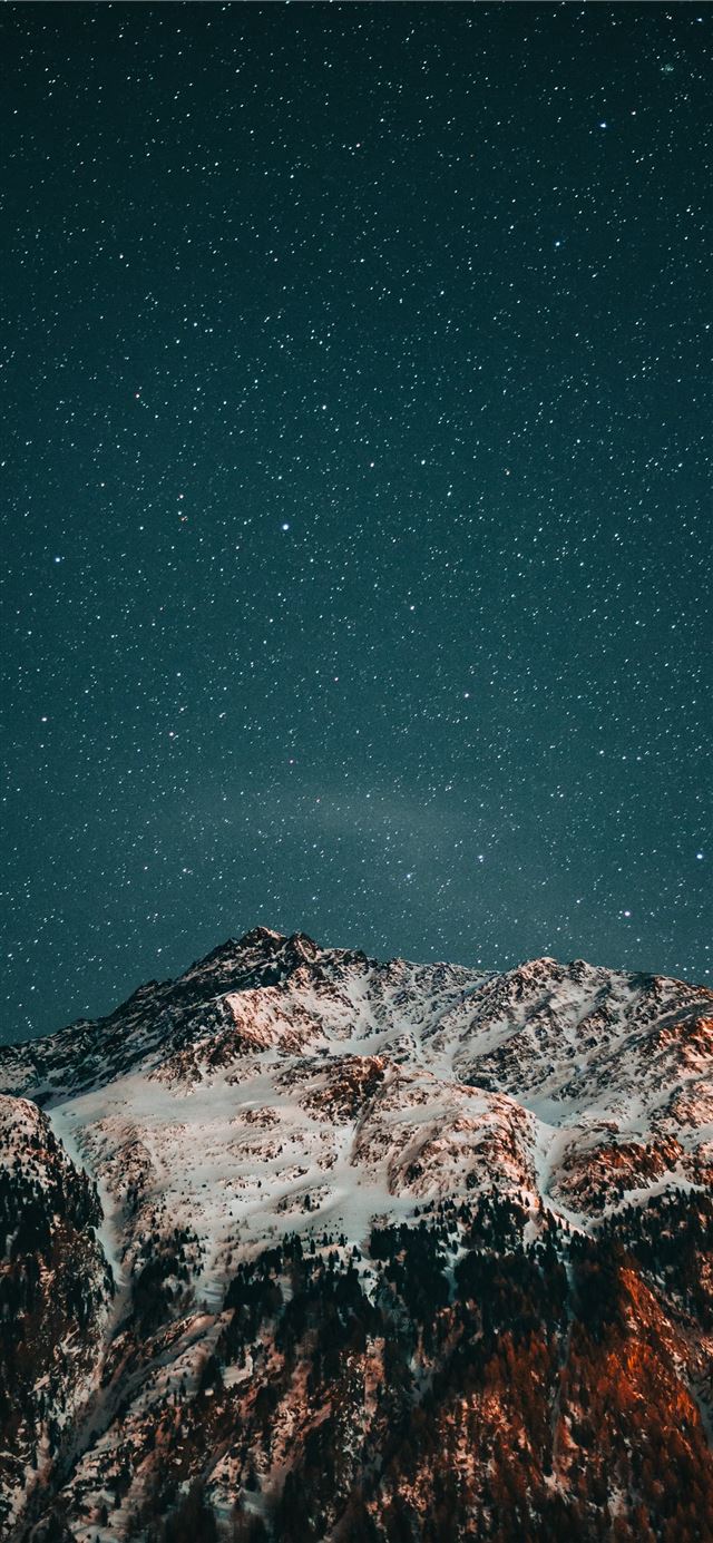 snow covered mountain under starry night iPhone X wallpaper 