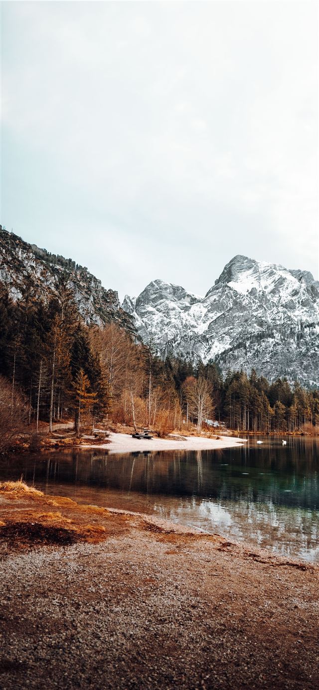 lake surrounded by trees and mountains during dayt... iPhone X wallpaper 