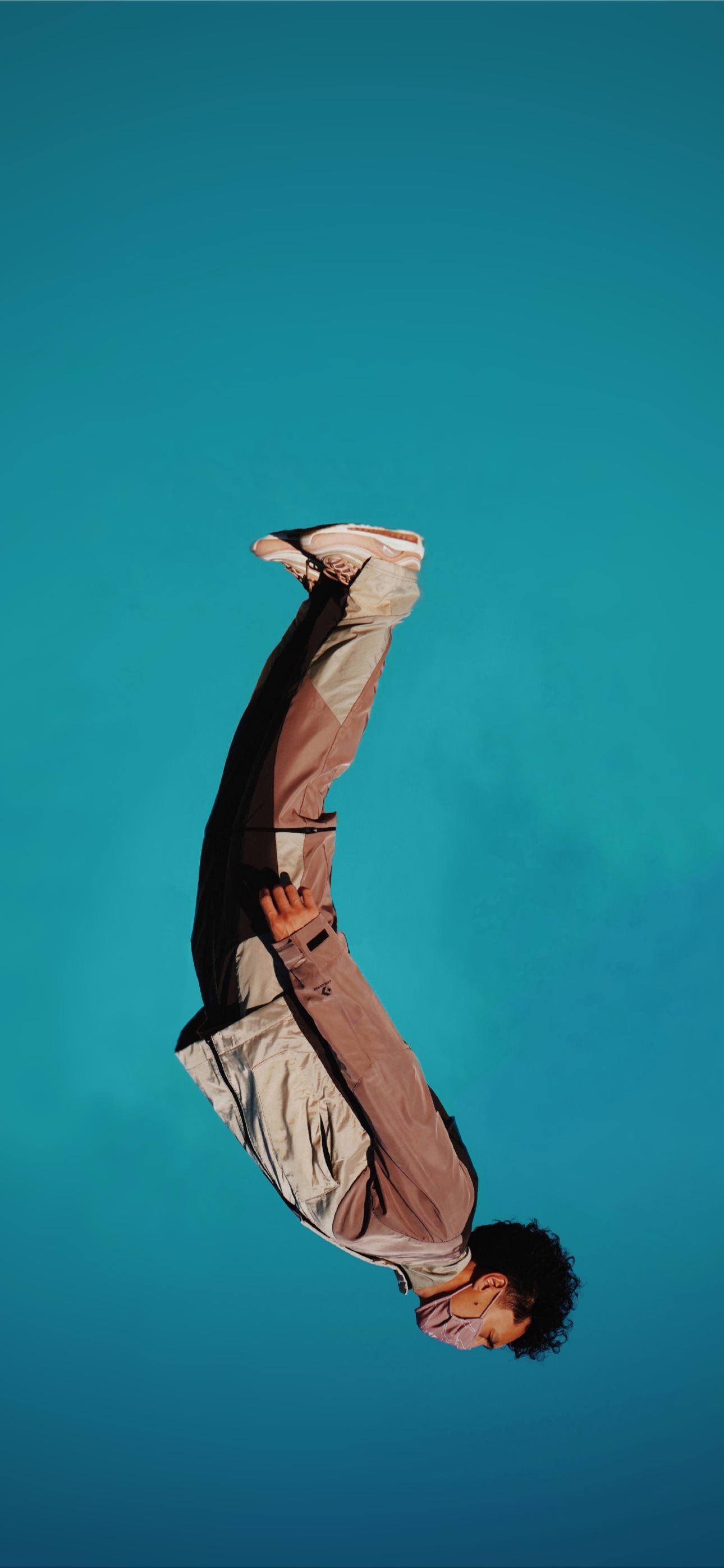 man in brown jacket and black pants iPhone Wallpapers Free Download