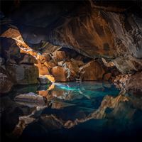 iceland cave surrouned with blue body of water 5k wallpaper