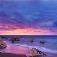 sunset ocean water rock beach 5k wallpaper