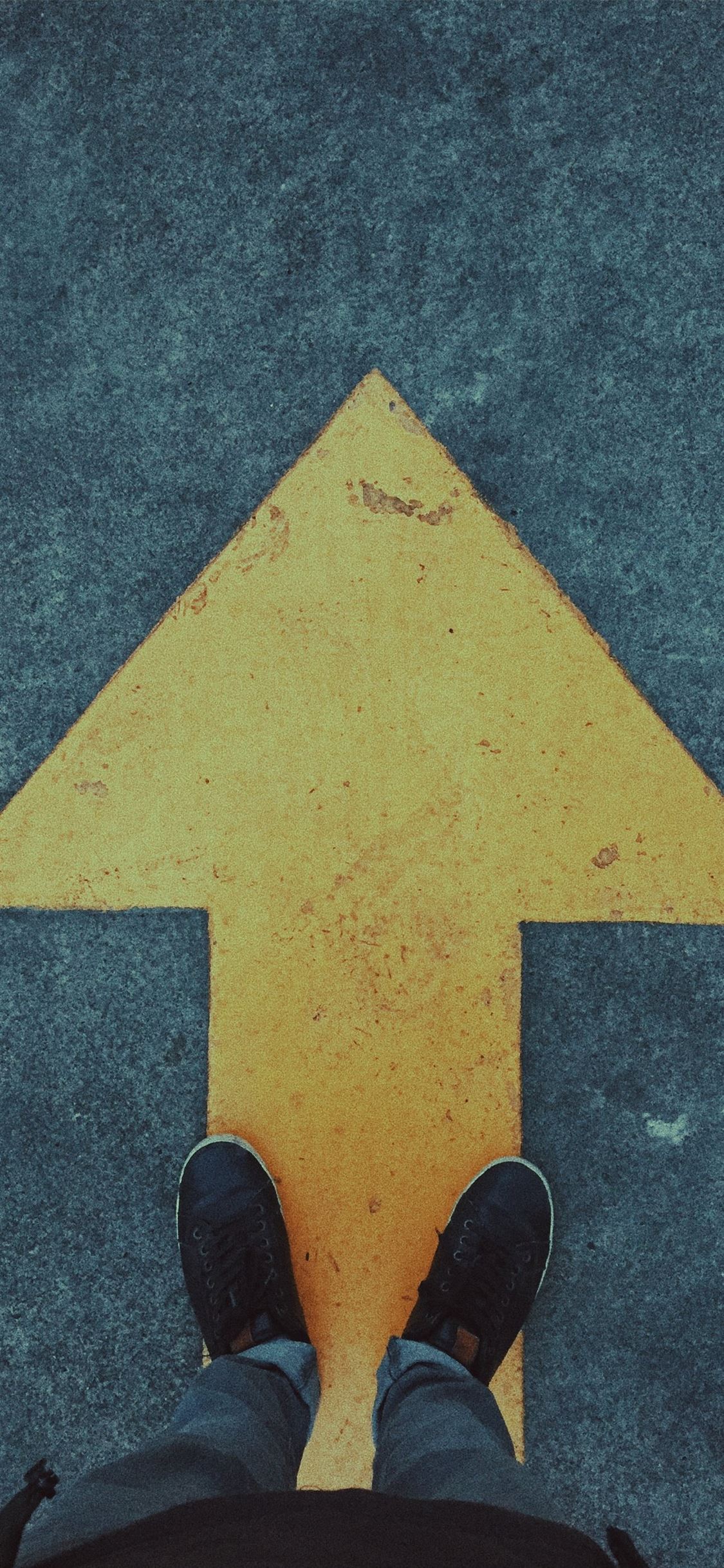 person standing on yellow arrow iPhone wallpaper 