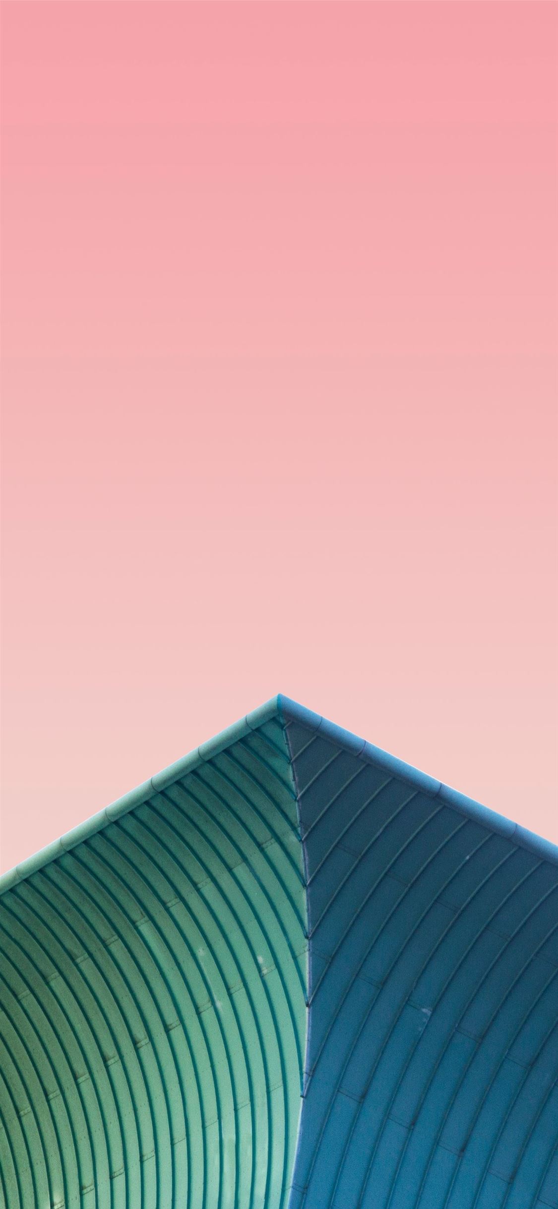 a plane flying over a building with a pink sky in ... iPhone wallpaper 