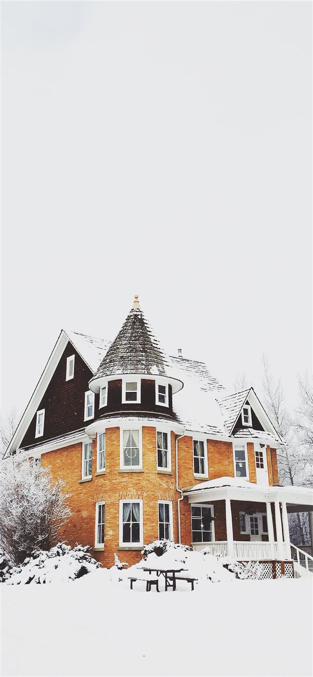 1125x2436 orange and gray concrete house surround by snow - bricks iPhone 11 Wallpaper