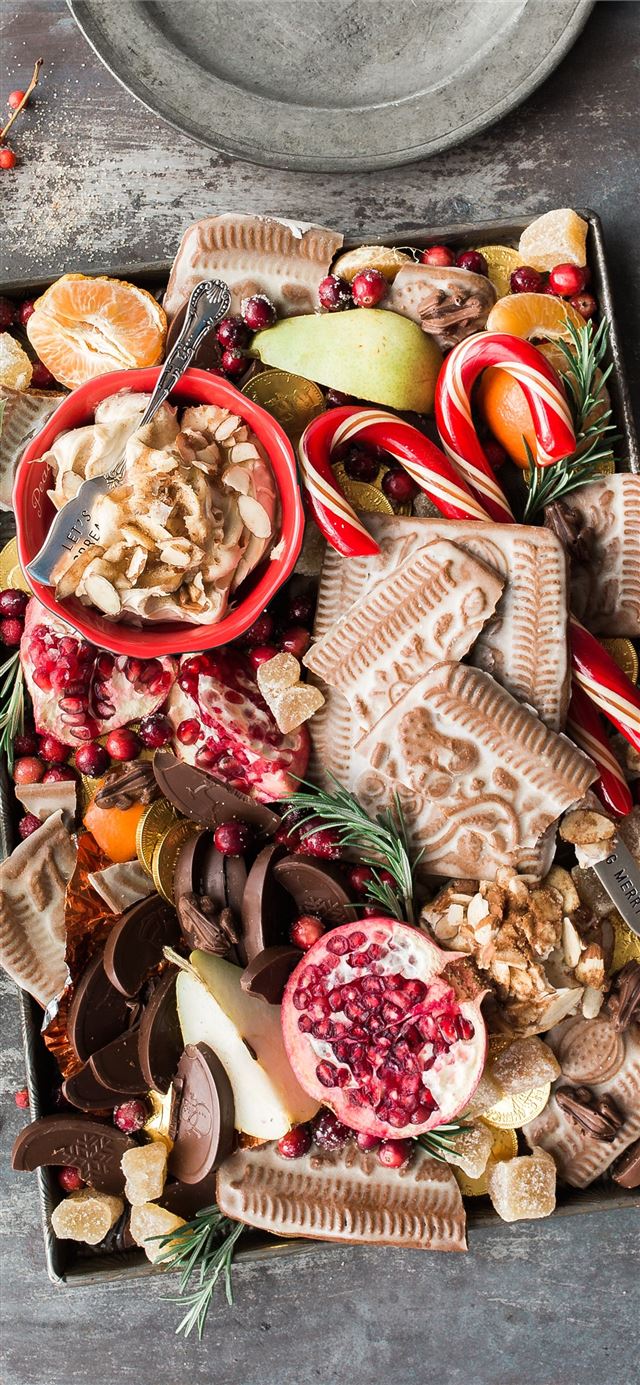 1125x2436 variety of sliced fruits cookies and chocolates on... - christmas iPhone 11 Wallpaper