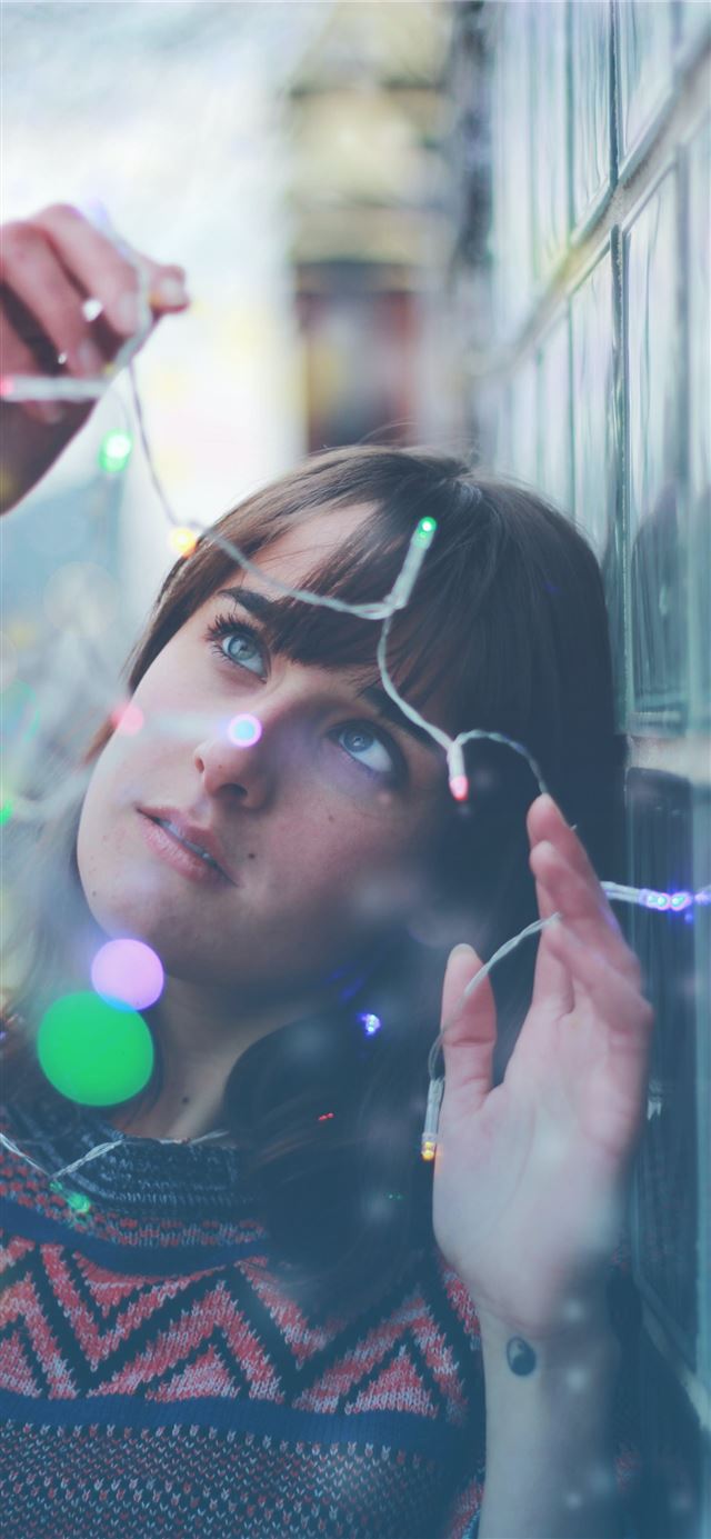 1125x2436 woman holding string lights - canada iPhone 11 Wallpaper