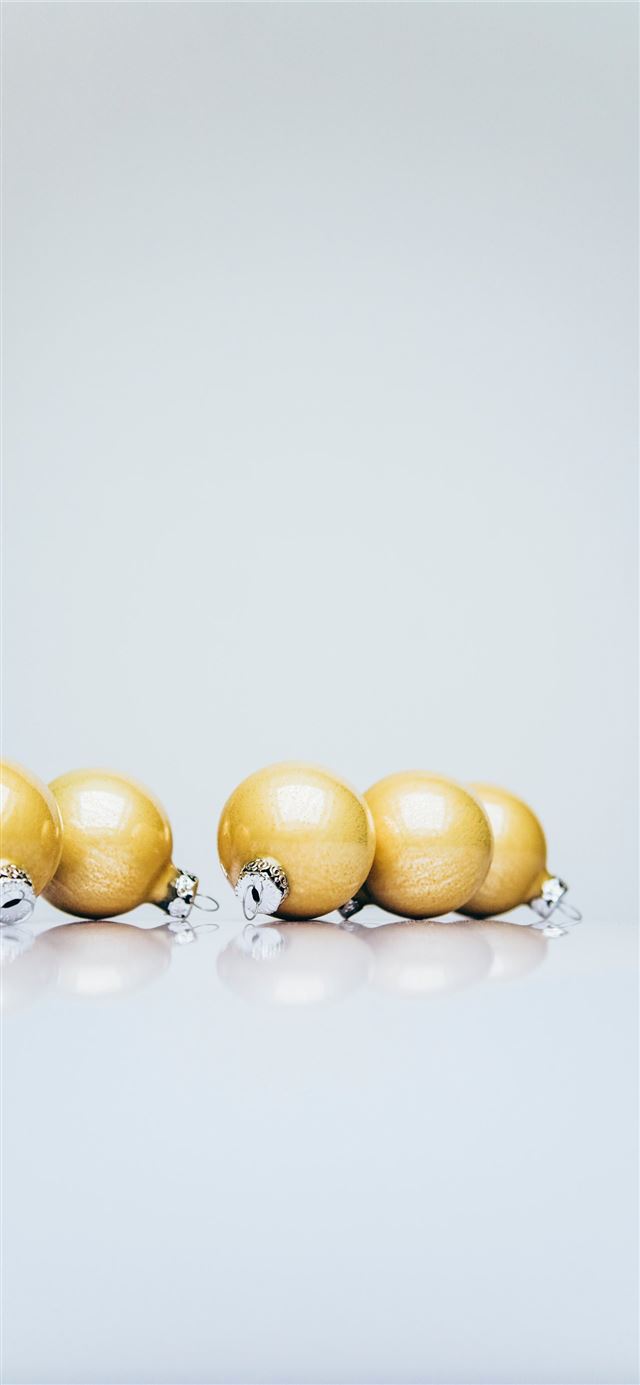 1125x2436 six gold Christmas baubles on white wooden surface - winter iPhone 11 Wallpaper