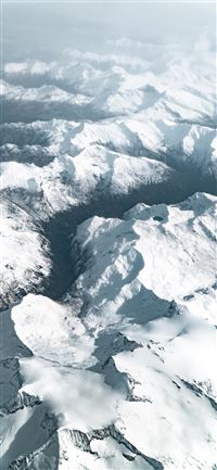 aerial photography of snow covered mountains durin... wallpaper