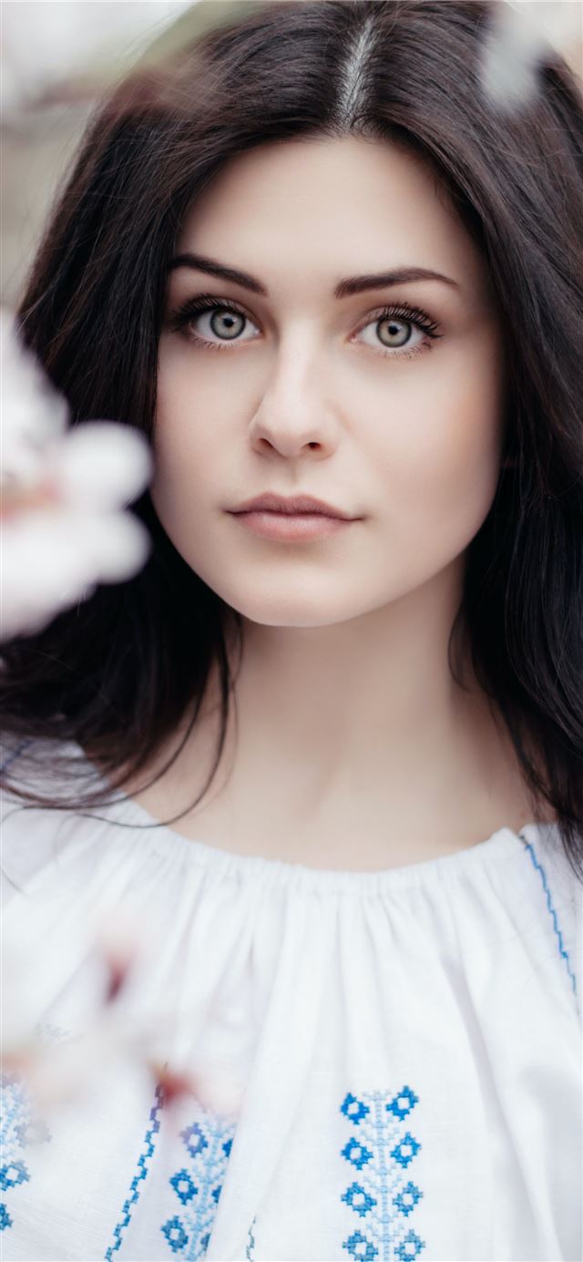 1125x2436 woman standing near white petaled flower -  iPhone 11 Wallpaper