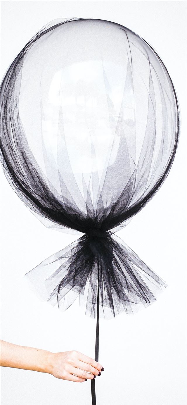 1125x2436 person holding black balloon decal - sydney iPhone 11 Wallpaper