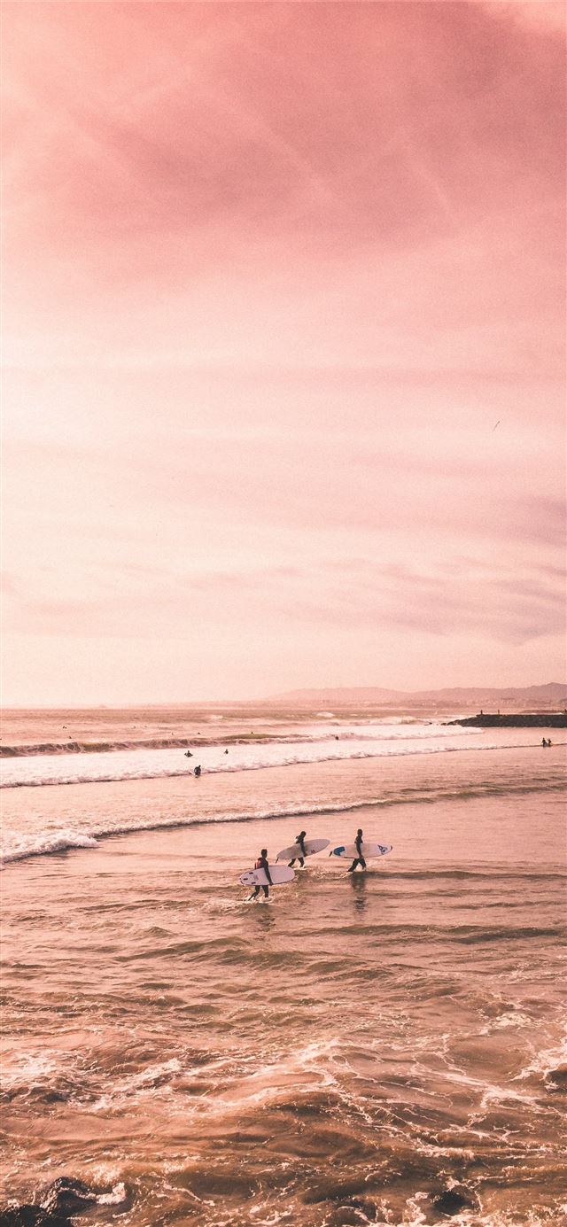 1125x2436 several people standing on seashore - portugal iPhone 11 Wallpaper
