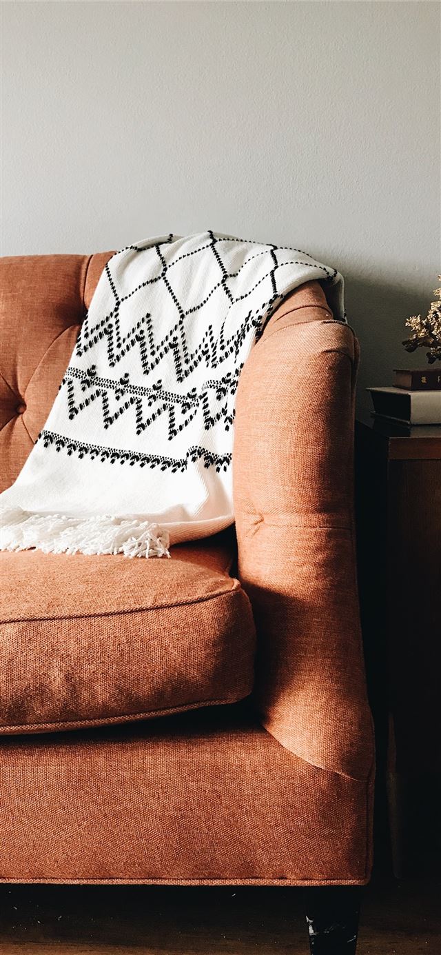1125x2436 white and black textile on brown couch - design iPhone 11 Wallpaper