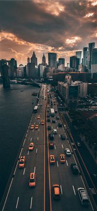 vehicles traveling on road iPhone 11 wallpaper