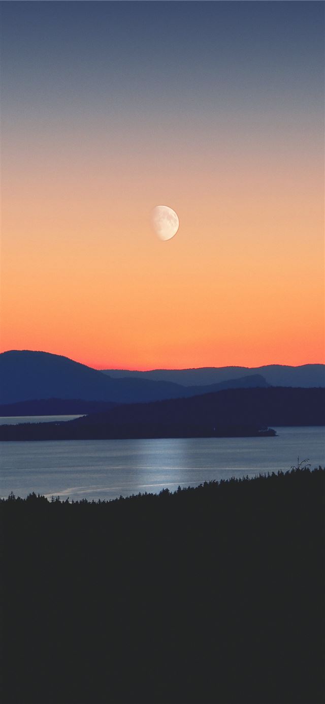 1125x2436 silhouette of mountains next to body of water - sky iPhone 11 Wallpaper