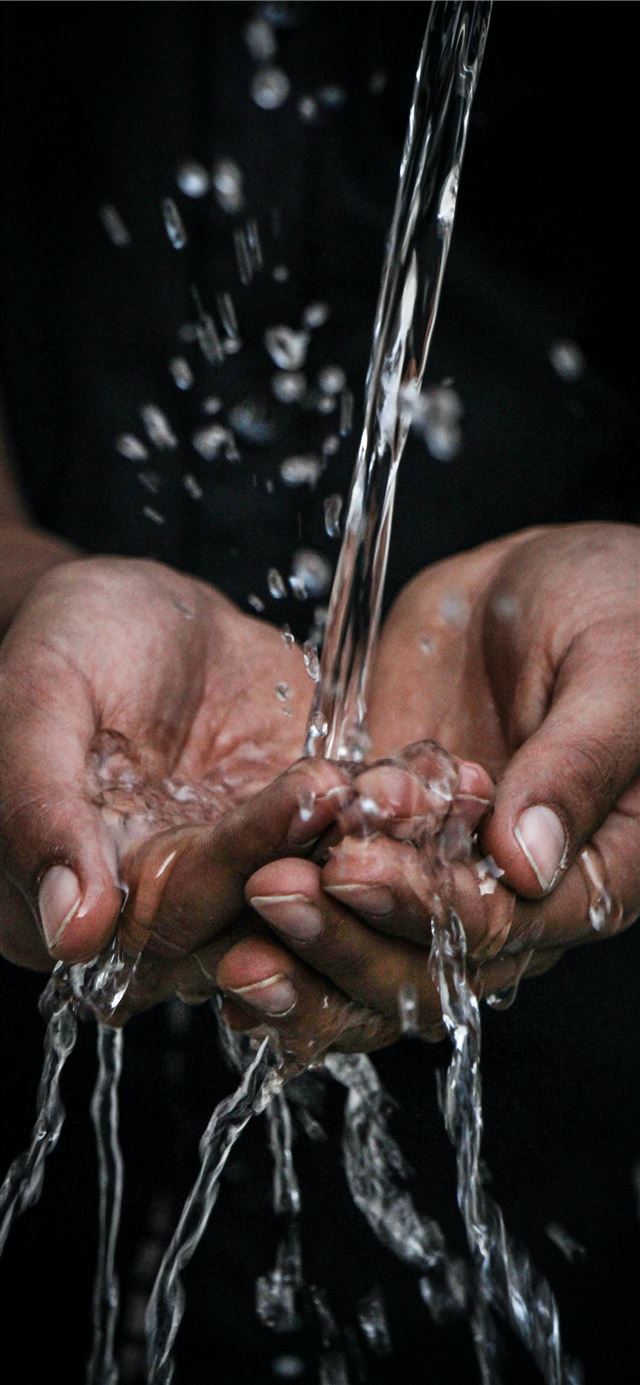 1125x2436 pouring water on person's hands - water iPhone 11 Wallpaper