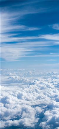 above cloud photo of blue skies iPhone 11 wallpaper