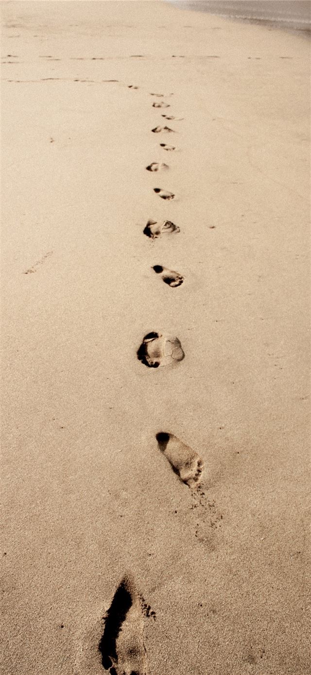 1125x2436 photo of footprints in the sand - indonesia iPhone 11 Wallpaper