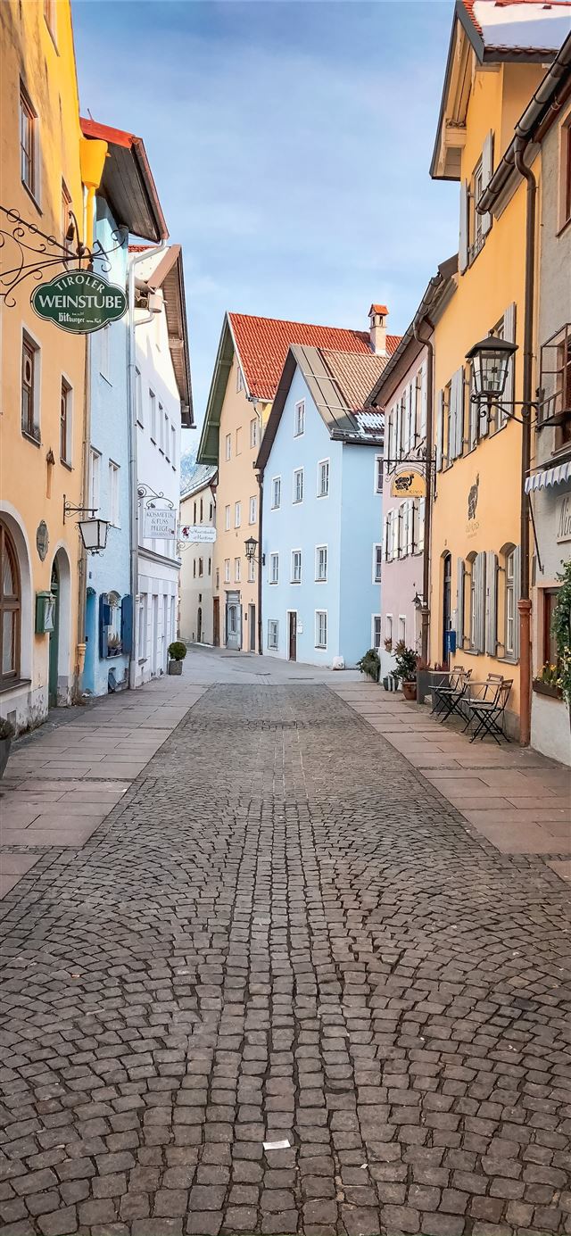 1125x2436 empty street between concrete buildings during day... - road iPhone 11 Wallpaper