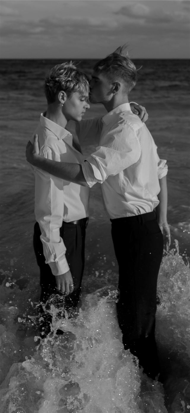 1125x2436 grayscale photo of two man standing on body of wat... - water iPhone 11 Wallpaper