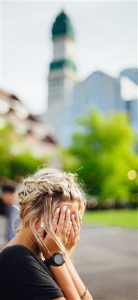 person covering face with hands outdoors iPhone 11 wallpaper