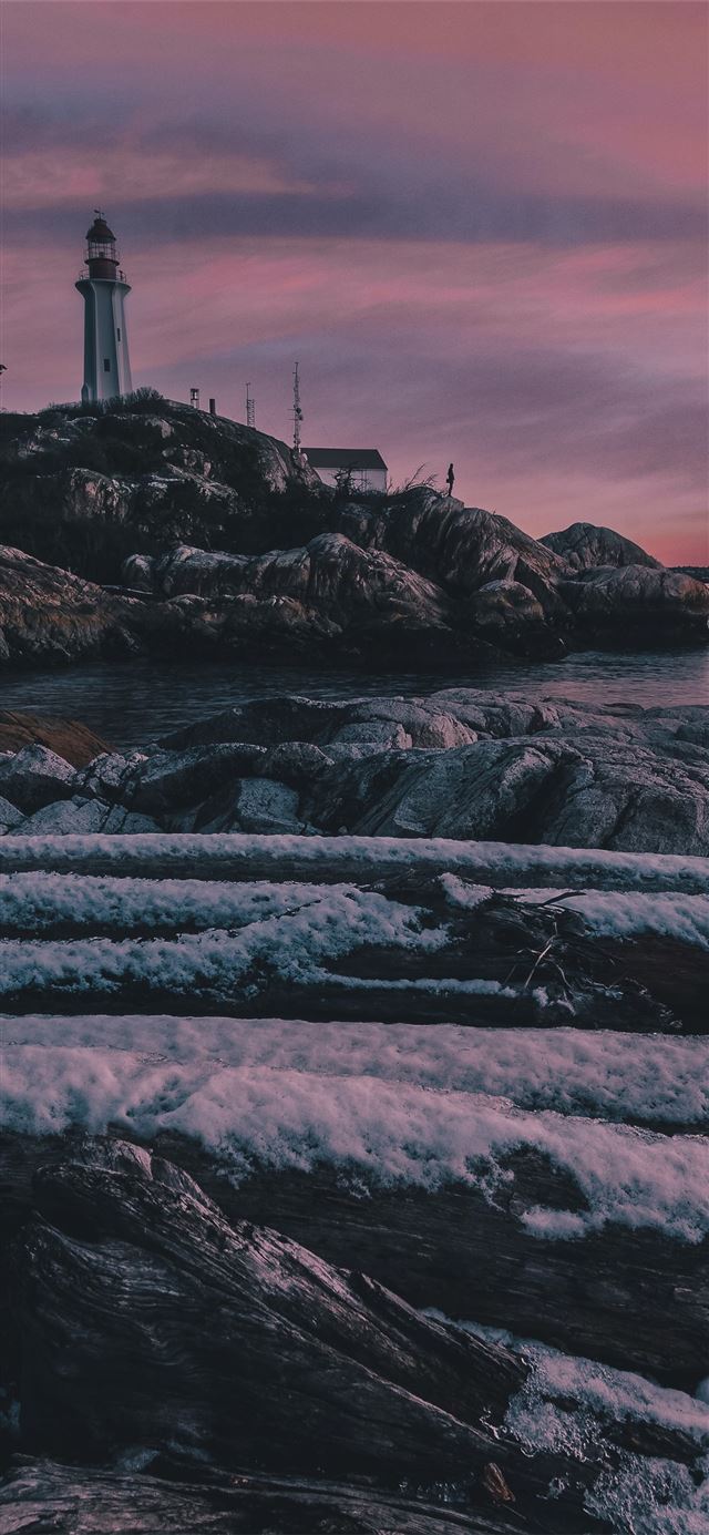 1125x2436 rock formation in front of calm body of water - sunset iPhone 11 Wallpaper