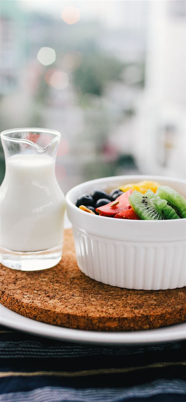 1125x2436 fruit salad inside bowl beside glass of milk on br... - health iPhone 11 Wallpaper