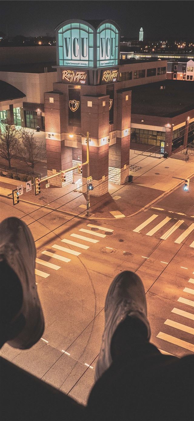 1125x2436 person sitting on top of building overlooking ligh... - road iPhone 11 Wallpaper