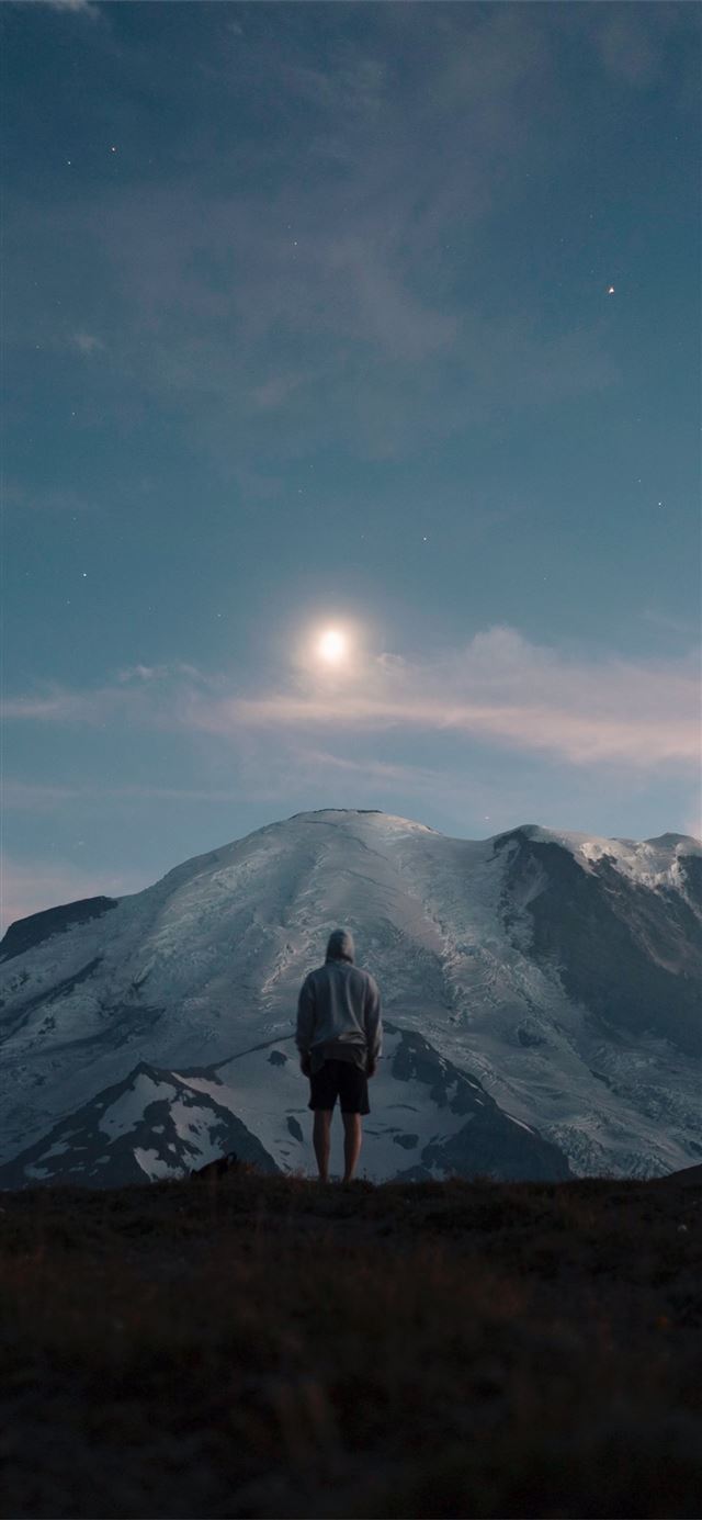 1125x2436 man standing on grass field overlooking mountain -  iPhone 11 Wallpaper
