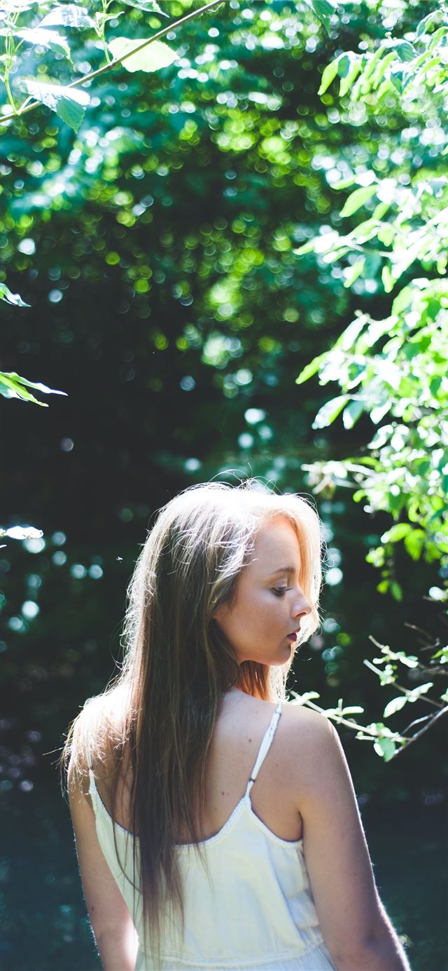 1125x2436 woman standing near tree during daytime - girl iPhone 11 Wallpaper